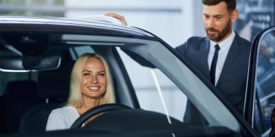 salesman-presenting-new-luxury-car-woman-showroom_7502-9537